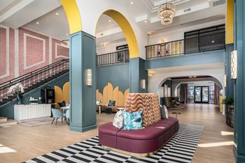 a lobby with a couch and a checkered rug